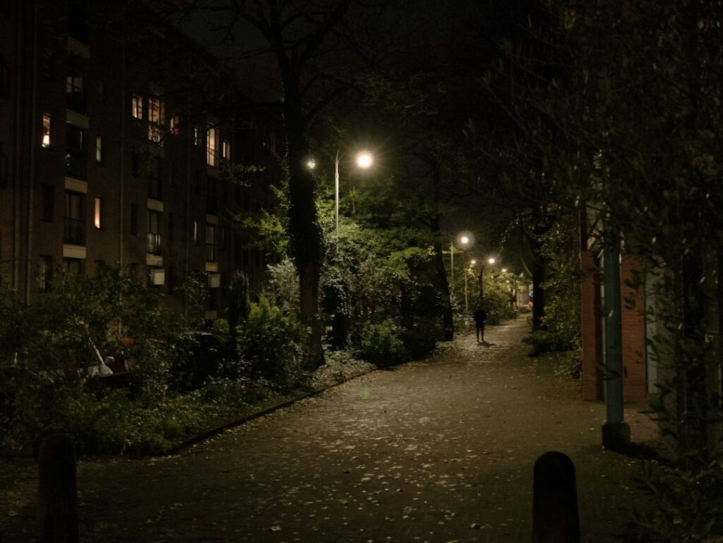 Dark street at night with street lights, symbolising the rising security threat to UK crypto holders