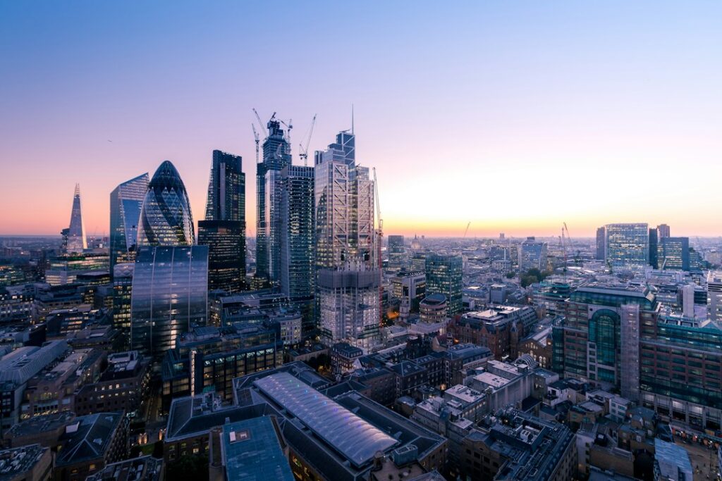 Aerial view of historic financial buildings and modern skyscrapers in the City of London representing UK regulatory authority.
