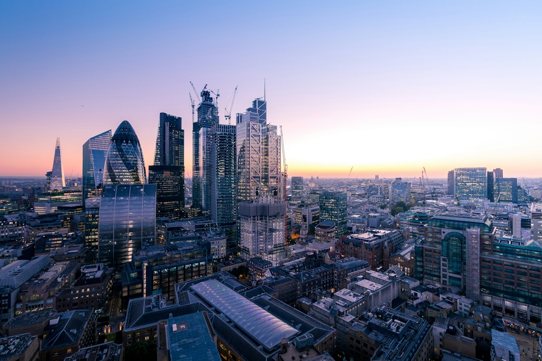 Aerial view of historic financial buildings and modern skyscrapers in the City of London representing UK regulatory authority.