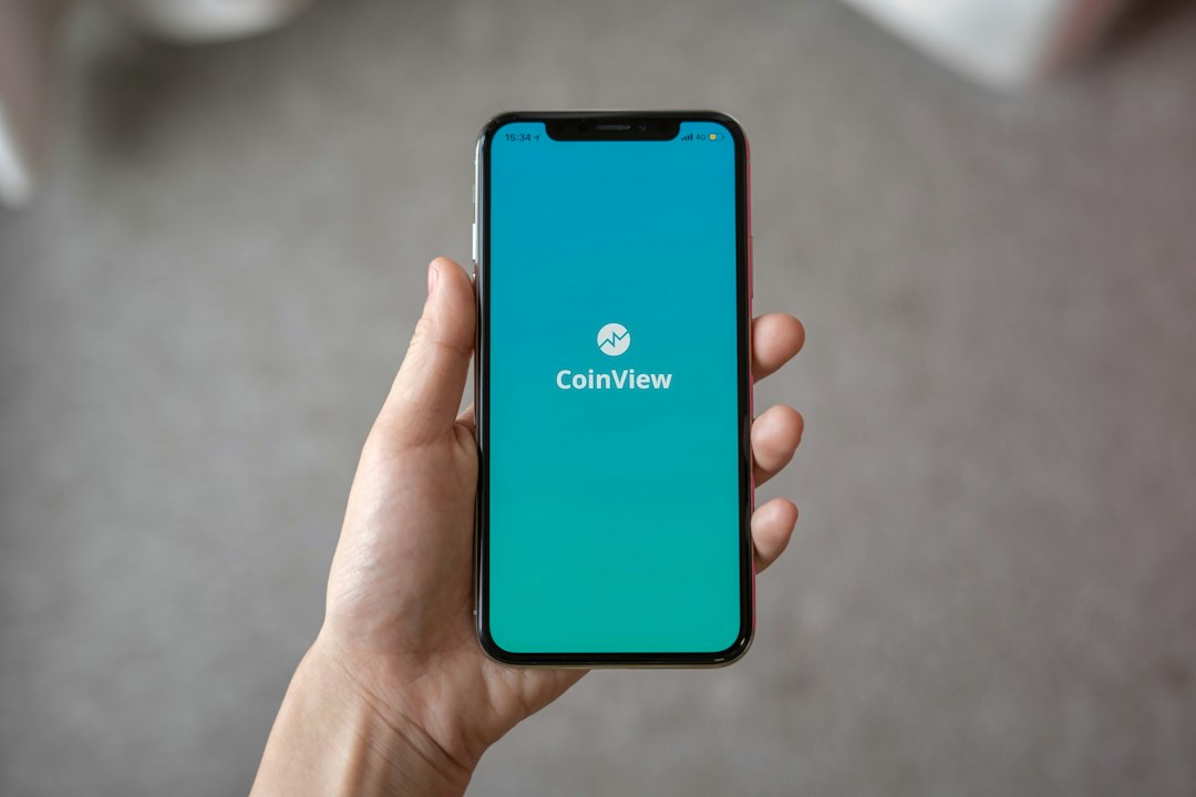 Person holding a smartphone showing an app
