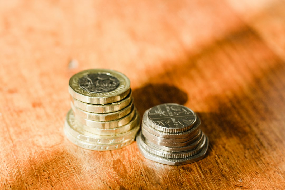 A silver and gold round coin representing digital assets and cryptocurrency on a reflective surface