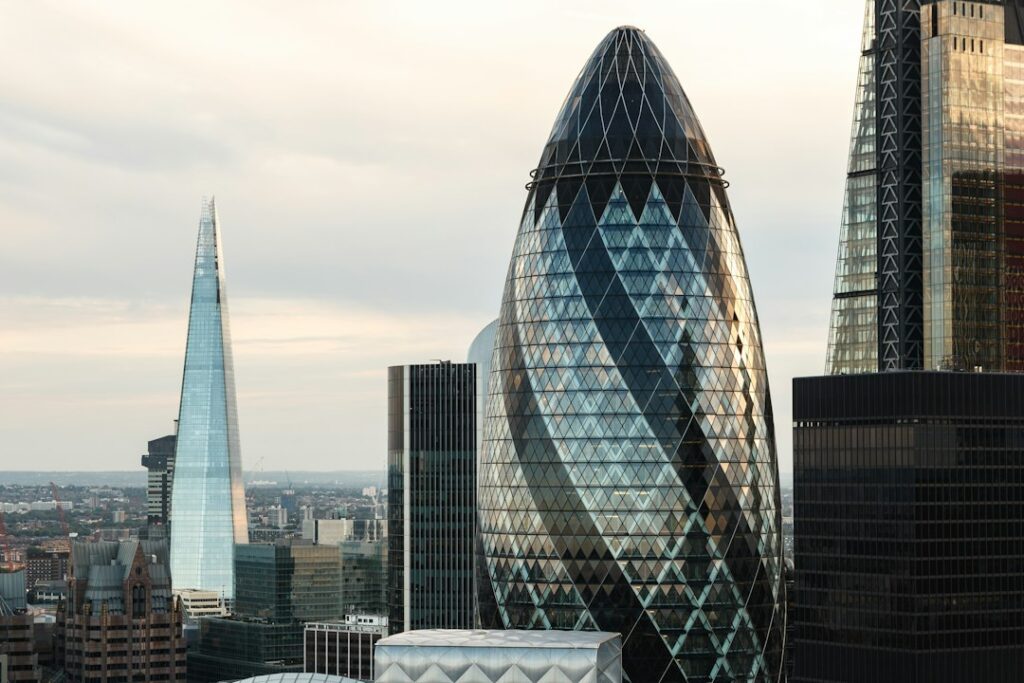 The Shard and 30 St Mary Axe skyscrapers in the London skyline under a blue sky